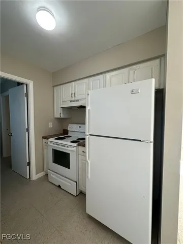a white refrigerator freezer sitting in a kitchen