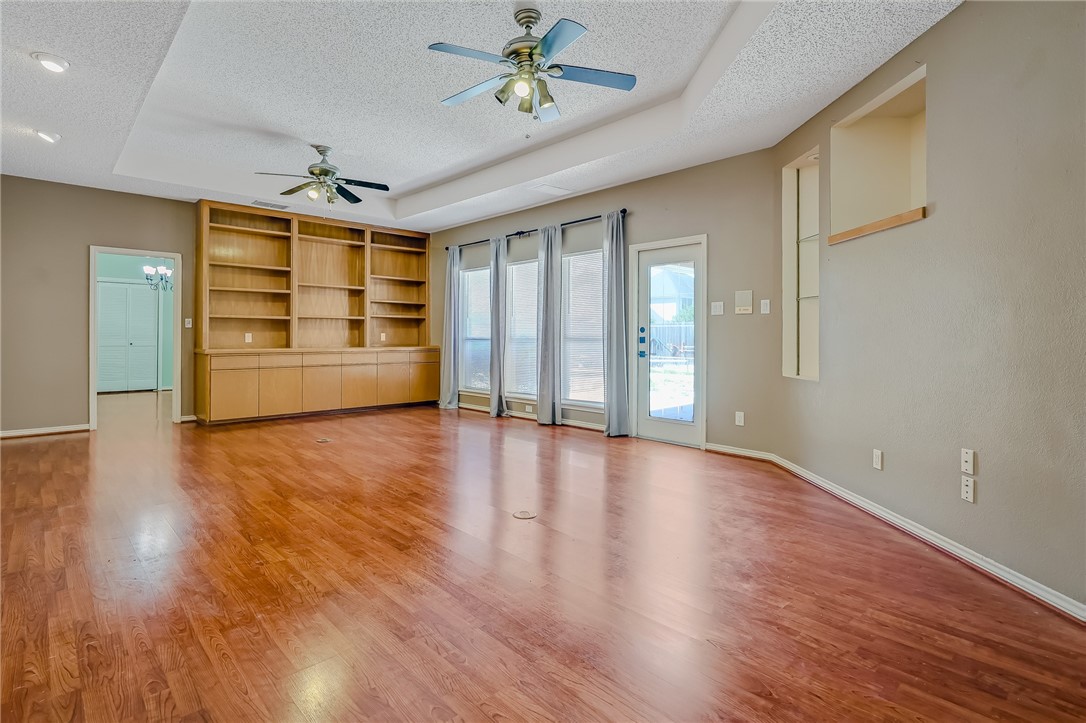 5917 Harvest Hill Road Corpus Christi, TX 78414 - Photo 10 of 40 a view of an empty room with a window and wooden floor