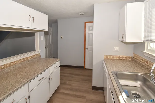 a kitchen with stainless steel appliances granite countertop a sink and a microwave