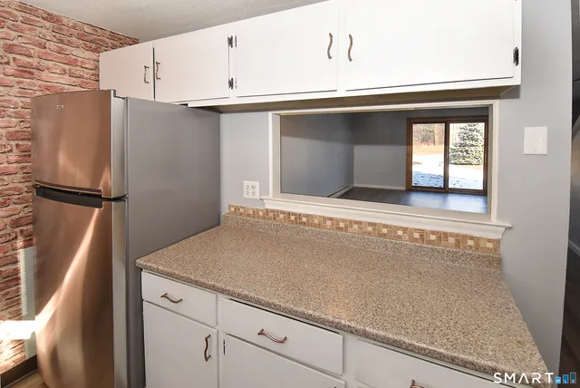 a kitchen with a refrigerator and cabinets
