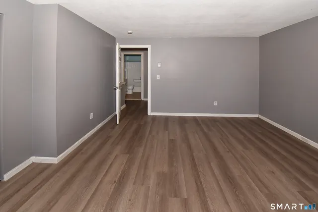 a view of a room with wooden floor