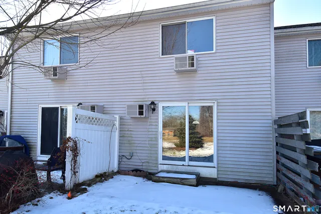 a view of a yard covered with snow in front of house