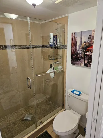 a bathroom with a toilet and a shower