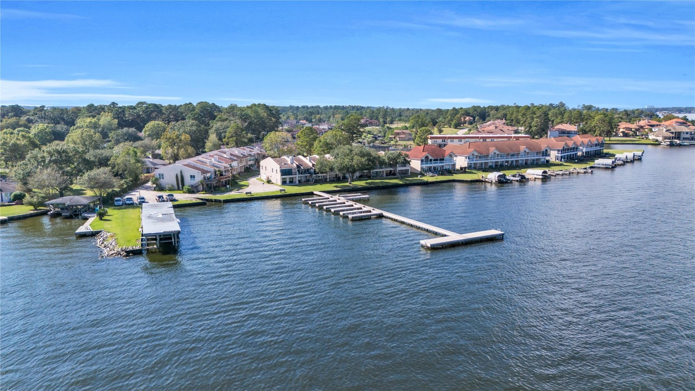 30 Regency Montgomery, TX 77356 - Photo 2 of 47 Your waterfront condo awaits you at the begging of the pier next to the drive leading to the loading dock.