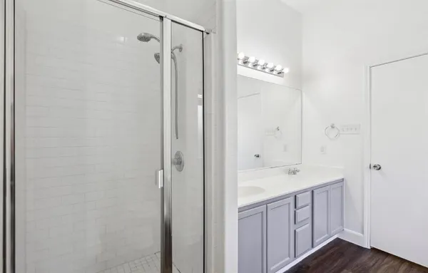 a spacious bathroom with a shower and a sink