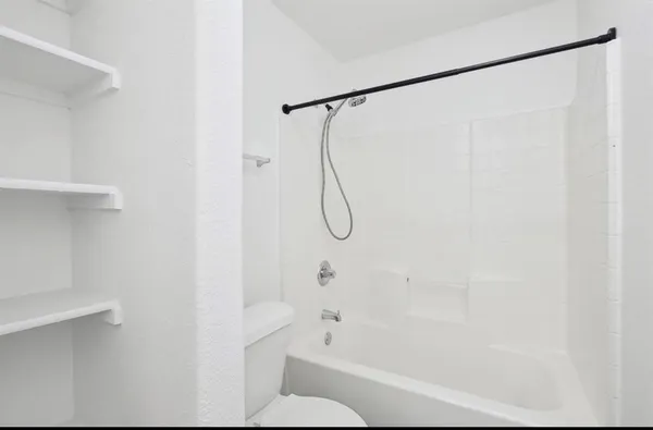 a bathroom with a shower and a shower head