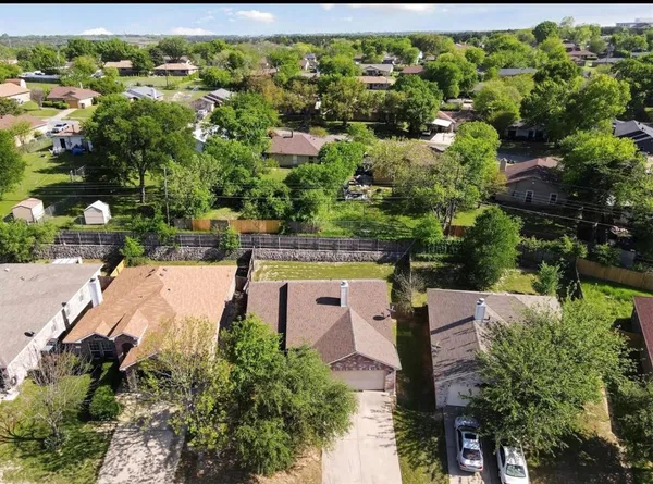 an aerial view of a house with a yard