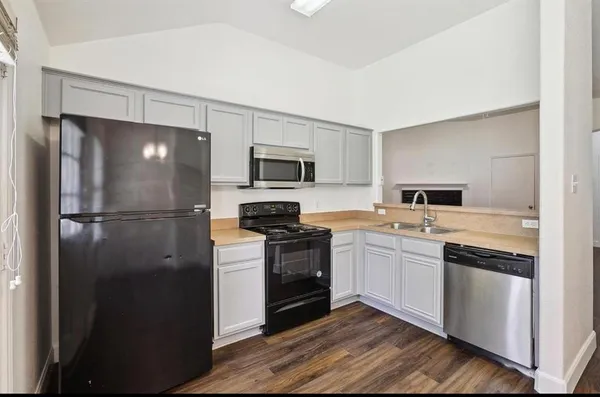 a kitchen with a refrigerator stove and sink