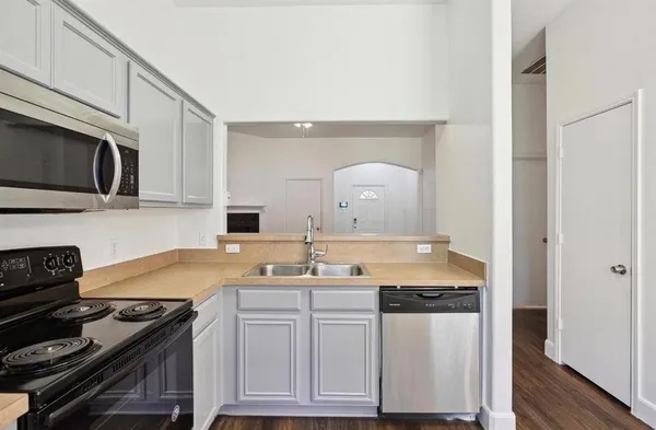 a kitchen with granite countertop a stove and a sink
