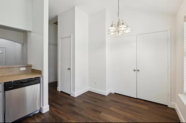 a view of a kitchen with stove and wooden floor
