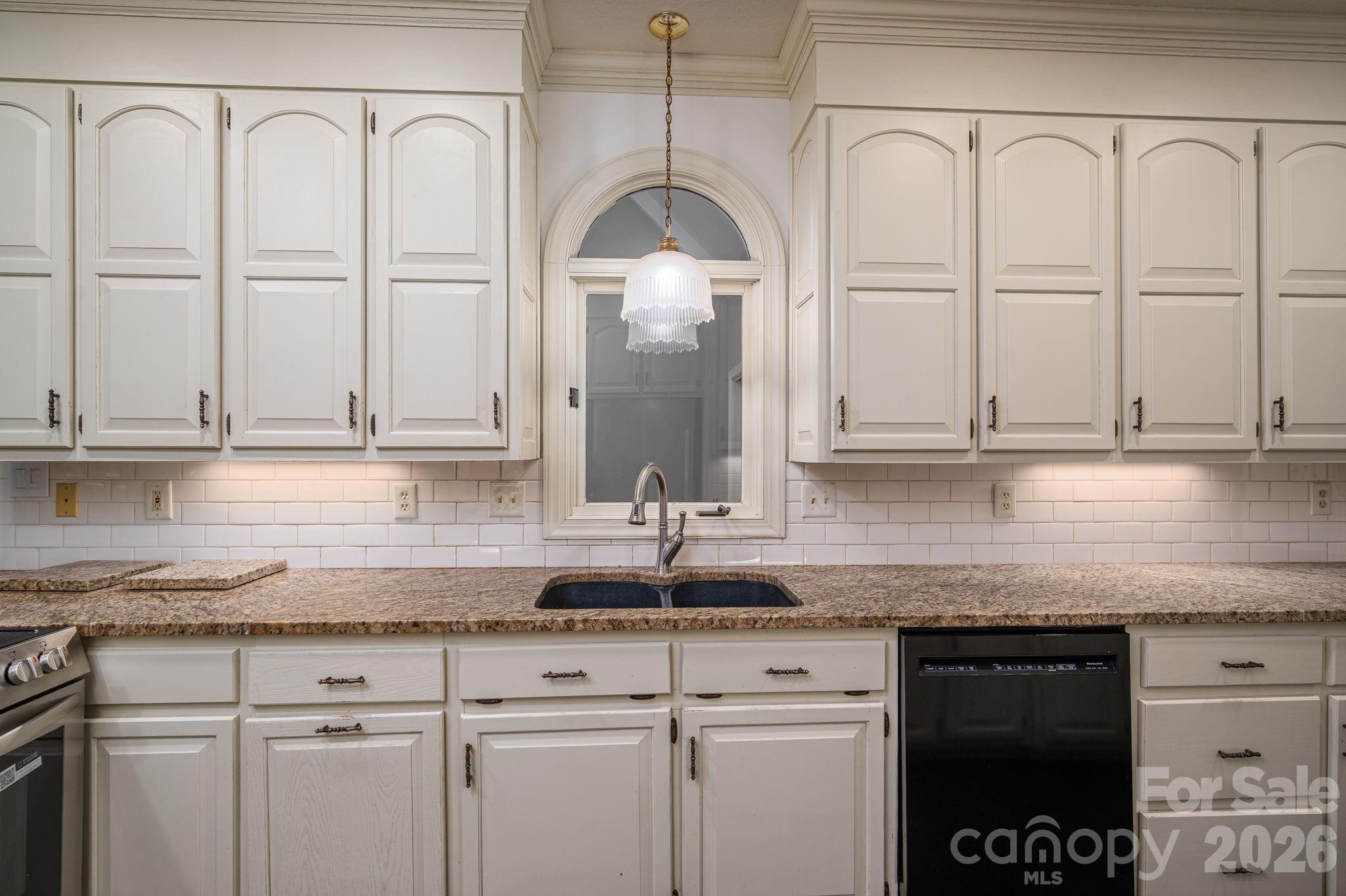 208 Hollow Road Lincolnton, NC 28092 - Photo 12 of 48 a kitchen with granite countertop white cabinets and sink