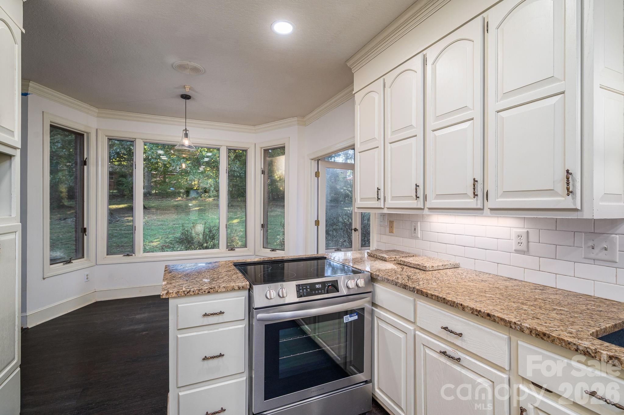 208 Hollow Road Lincolnton, NC 28092 - Photo 13 of 48 a kitchen with stainless steel appliances white cabinets and a granite counter tops
