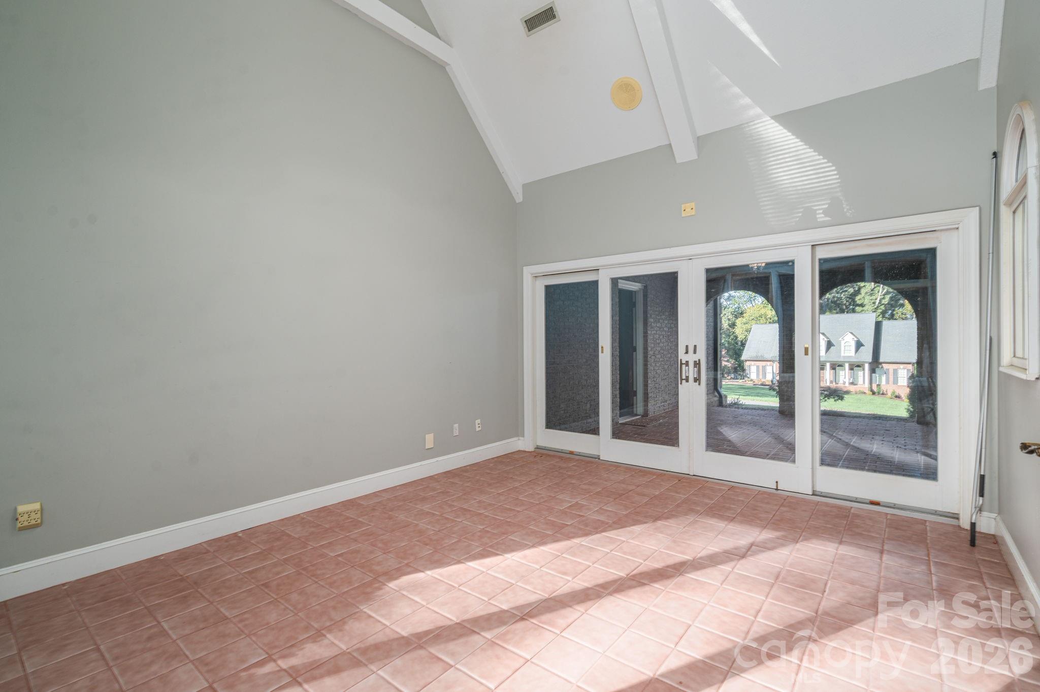 208 Hollow Road Lincolnton, NC 28092 - Photo 14 of 48 an empty room with floor to ceiling windows and a rug