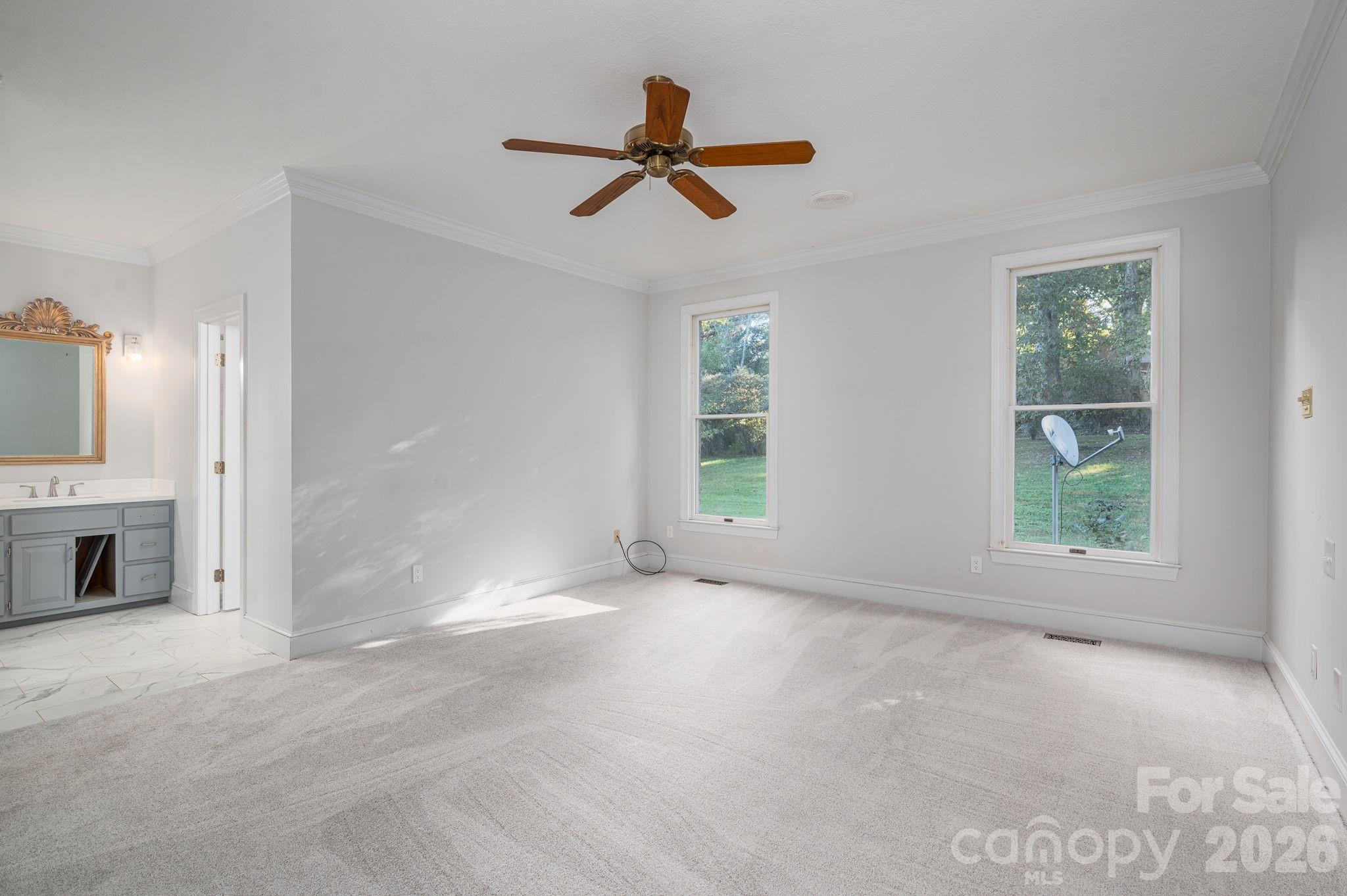 208 Hollow Road Lincolnton, NC 28092 - Photo 20 of 48 a view of empty room with windows and ceiling fan