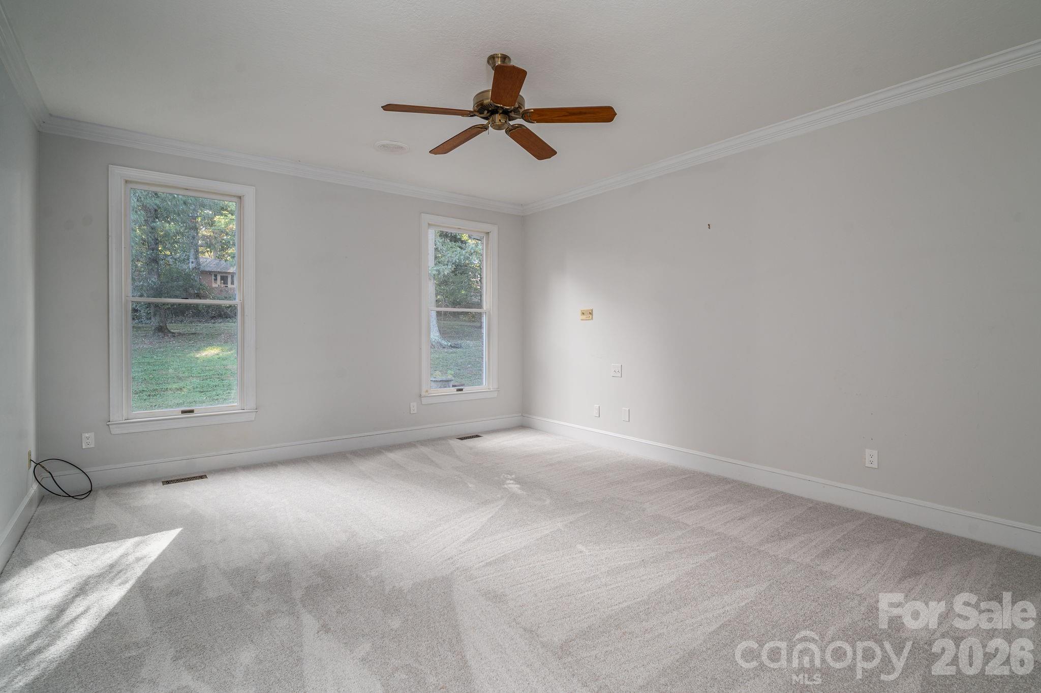 208 Hollow Road Lincolnton, NC 28092 - Photo 21 of 48 a view of a livingroom with a ceiling fan and window