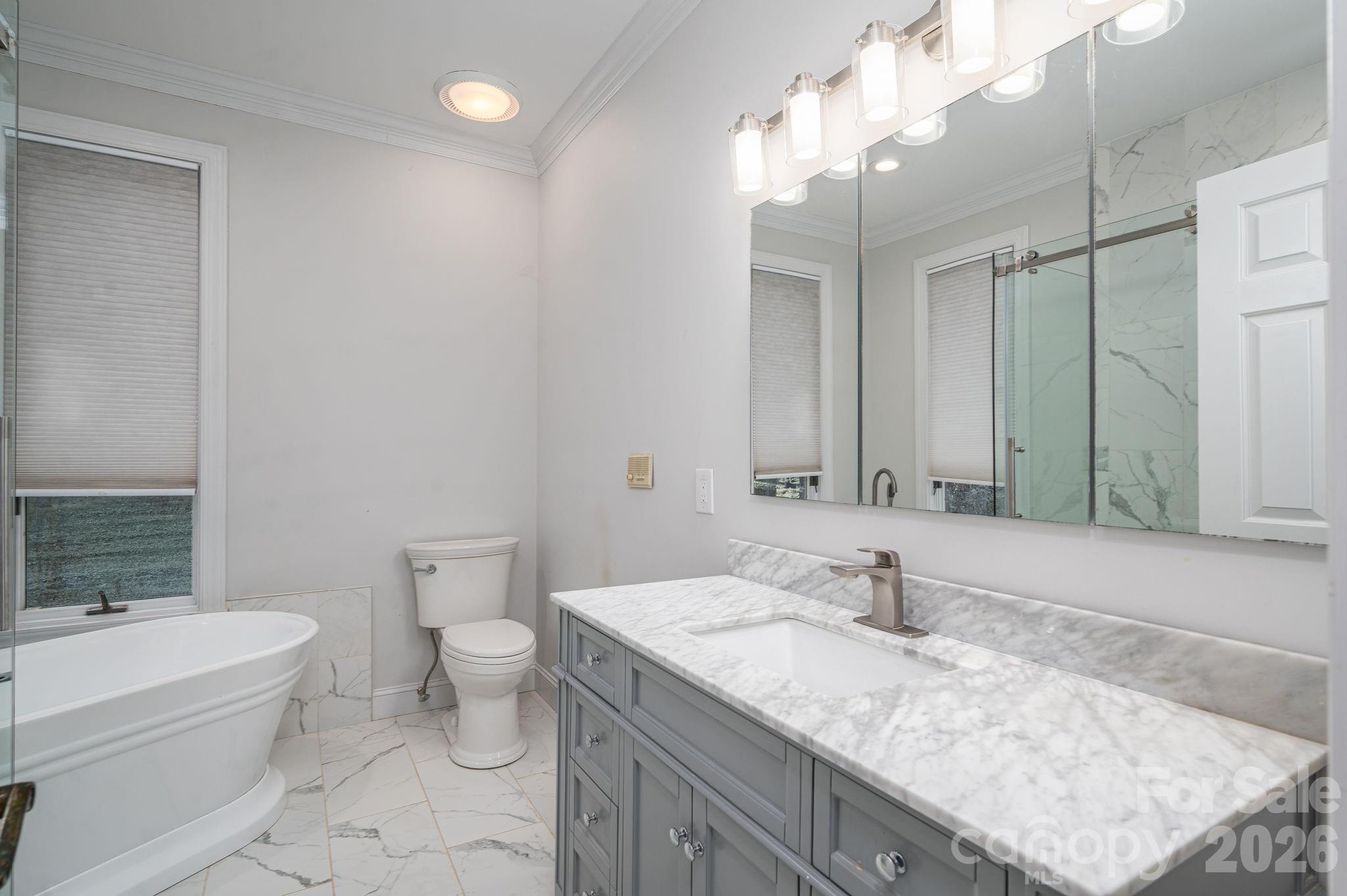 208 Hollow Road Lincolnton, NC 28092 - Photo 22 of 48 a bathroom with a granite countertop sink a toilet and bathtub