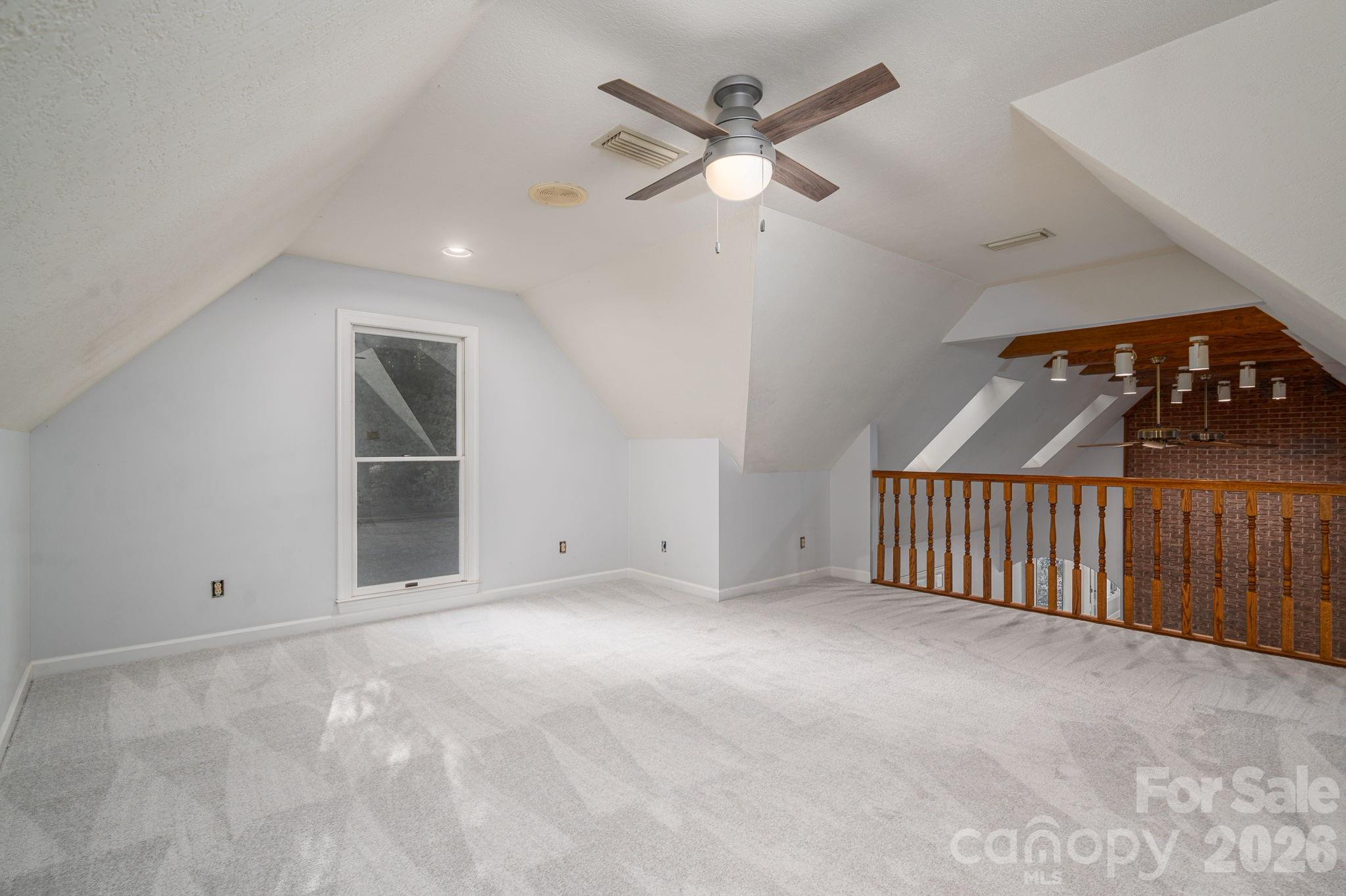 208 Hollow Road Lincolnton, NC 28092 - Photo 24 of 48 an empty room with windows and fan