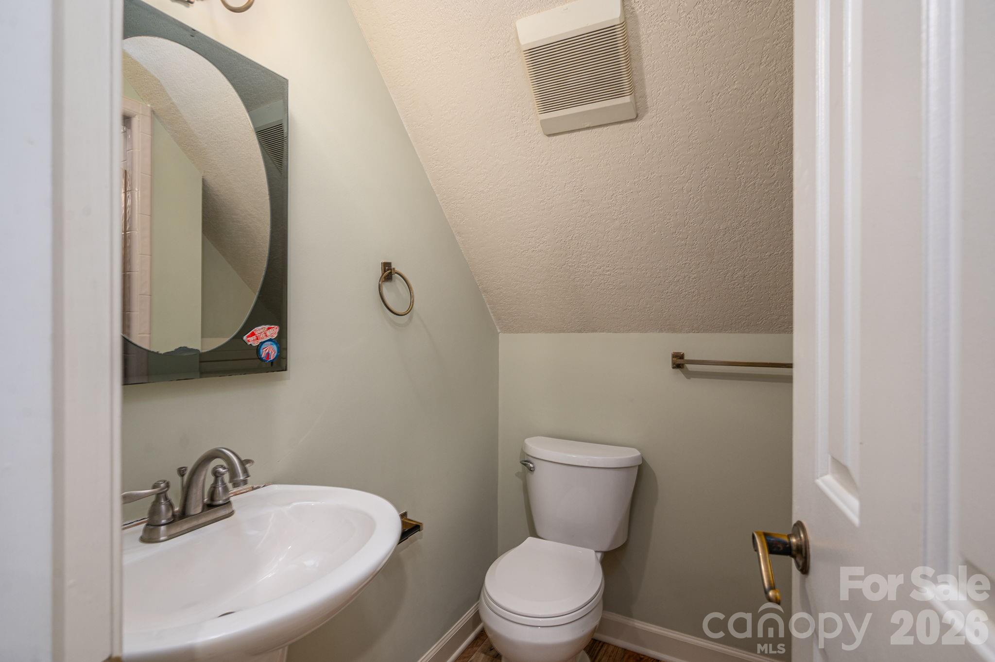 208 Hollow Road Lincolnton, NC 28092 - Photo 29 of 48 a bathroom with a toilet sink and mirror