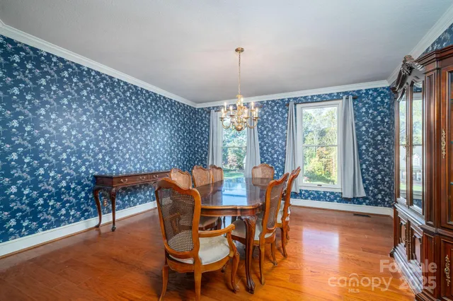 a dining room with furniture window and wooden floor