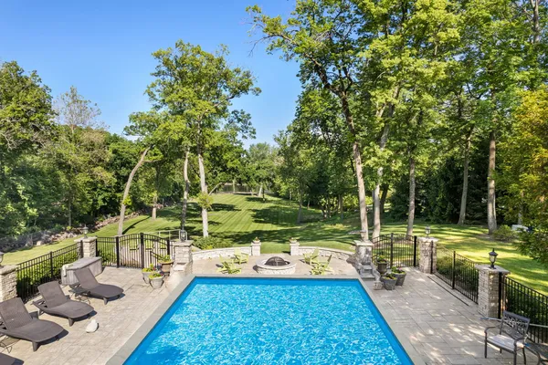 a view of yard with swimming pool and seating space
