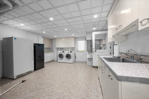 a kitchen with stainless steel appliances granite countertop a sink and a refrigerator
