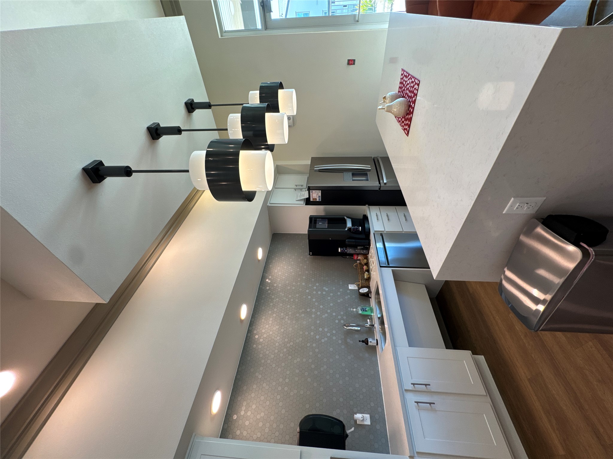 691 Union Chapel Road, Unit B1 Cedar Creek, TX 78612 - Photo 21 of 28 Kitchen with white cabinets, a center island, dark wood finished floors, appliances with stainless steel finishes, and decorative light fixtures