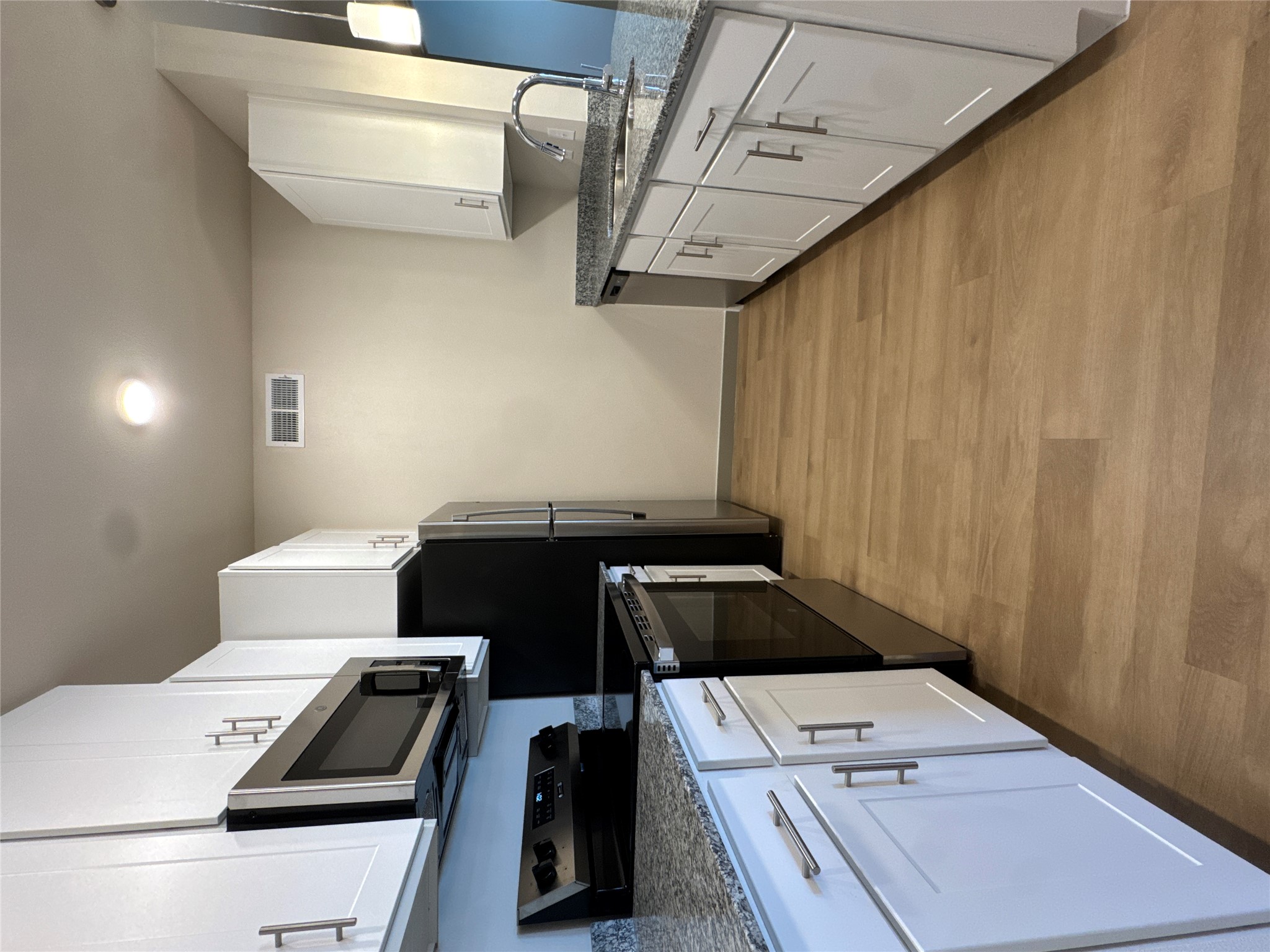 691 Union Chapel Road, Unit B1 Cedar Creek, TX 78612 - Photo 3 of 28 Kitchen featuring stainless steel appliances, stone countertops, white cabinetry, and light wood-style flooring
