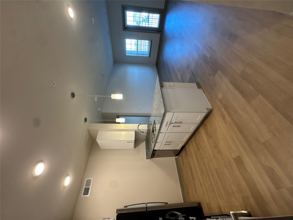 691 Union Chapel Road, Unit B1 Cedar Creek, TX 78612 - Photo 5 of 28 Kitchen featuring light stone countertops, recessed lighting, white cabinetry, pendant lighting, and wood style finished floors
