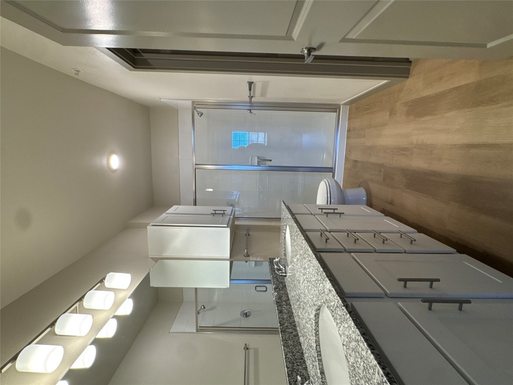 691 Union Chapel Road, Unit B1 Cedar Creek, TX 78612 - Photo 10 of 28 Bathroom with double vanity, a shower stall, and light wood-style floors