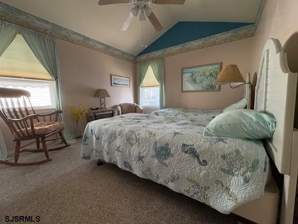 a bedroom with a bed a mirror and a large window