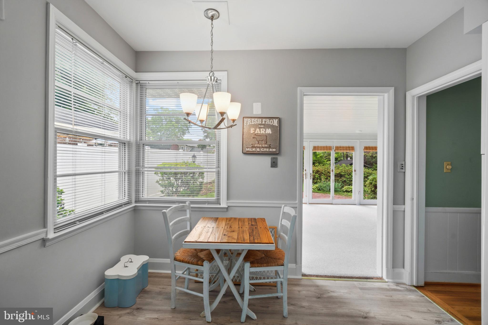 909 Weatherbee Road Towson, MD 21286 - Photo 17 of 51 a view of a dining room with furniture large windows and wooden floor