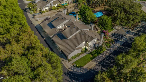 an aerial view of a house with a yard