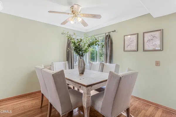 a view of a dining room with furniture window and wooden floor