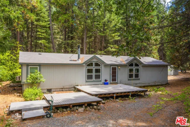 a view of a house with pool and chairs