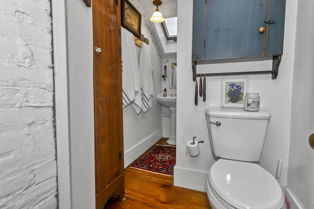 20 Auburn Street Chicopee, MA 01013 - Photo 25 of 36 a white toilet sitting next to a bathroom sink