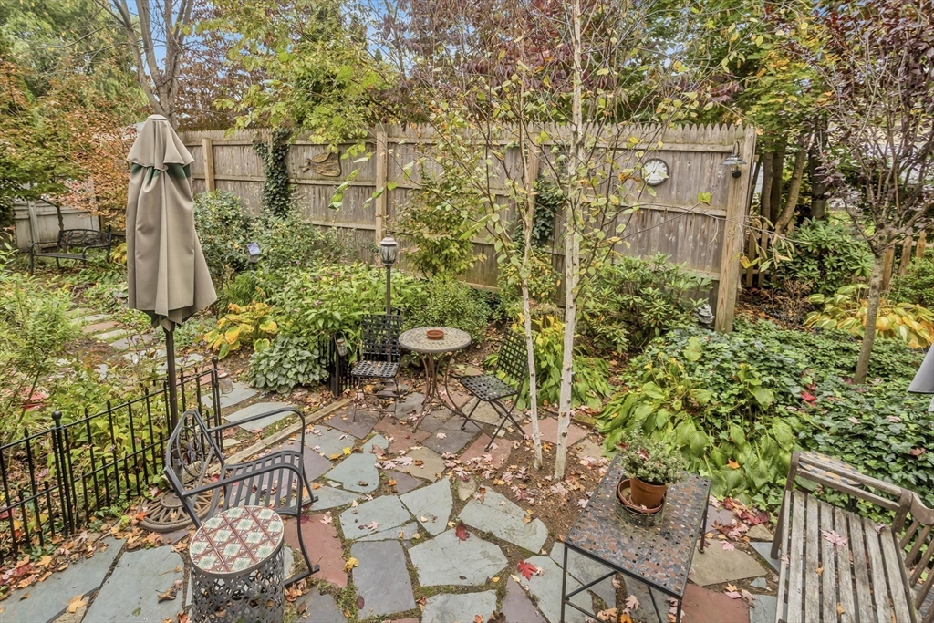 20 Auburn Street Chicopee, MA 01013 - Photo 30 of 36 a pathway of a house with a yard and chair