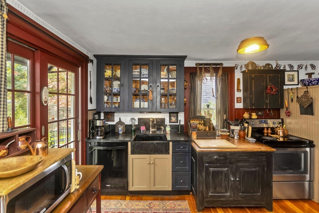 20 Auburn Street Chicopee, MA 01013 - Photo 8 of 36 a kitchen with stainless steel appliances granite countertop a stove and a sink