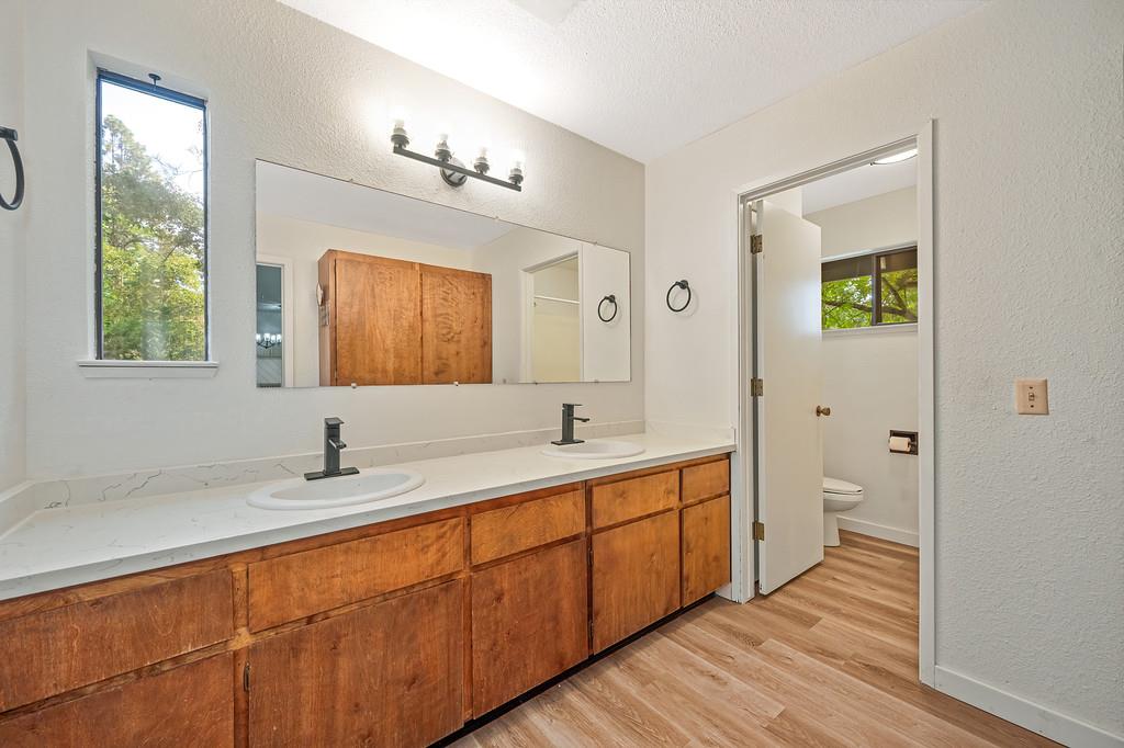 15358 Sky Pines Road Grass Valley, CA 95949 - Photo 15 of 37 Primary suite bath with double sinks, new counter tops and lighting. Separate room with commode and tub over shower