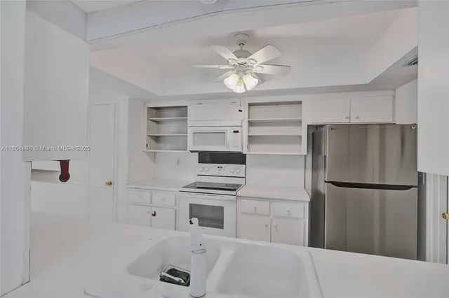 a kitchen with a refrigerator and cabinets