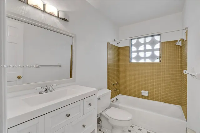 a bathroom with a sink mirror and shower