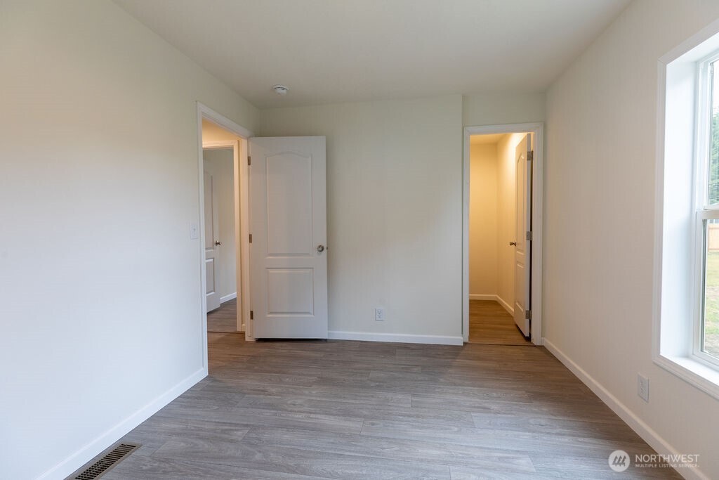 1450 Calawah Way Forks, WA 98331 - Photo 14 of 38 an empty room with wooden floor and windows