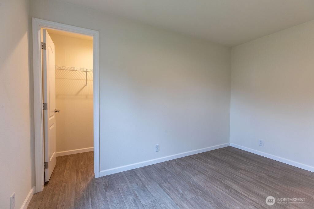 1450 Calawah Way Forks, WA 98331 - Photo 17 of 38 a view of an empty room with wooden floor and a window