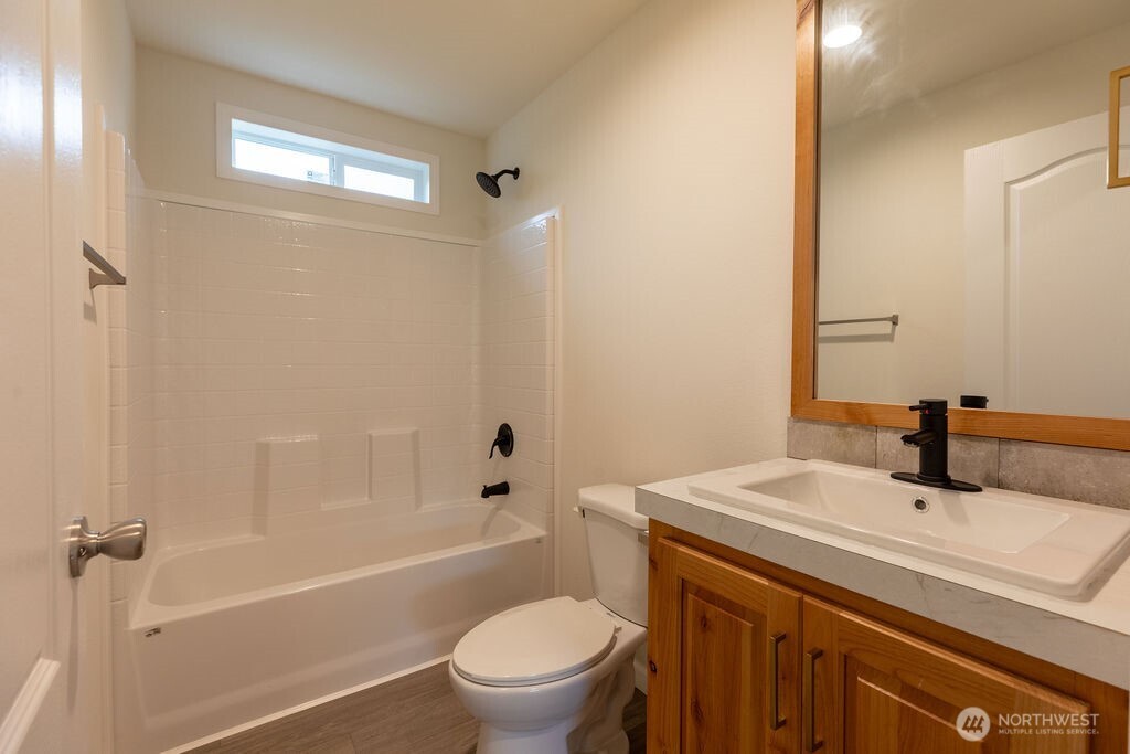 1450 Calawah Way Forks, WA 98331 - Photo 20 of 38 a bathroom with a sink a toilet and shower