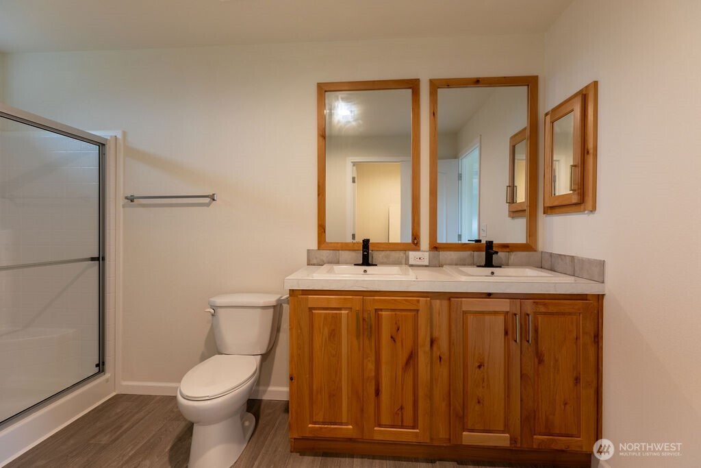 1450 Calawah Way Forks, WA 98331 - Photo 25 of 38 a bathroom with a toilet a sink and mirror