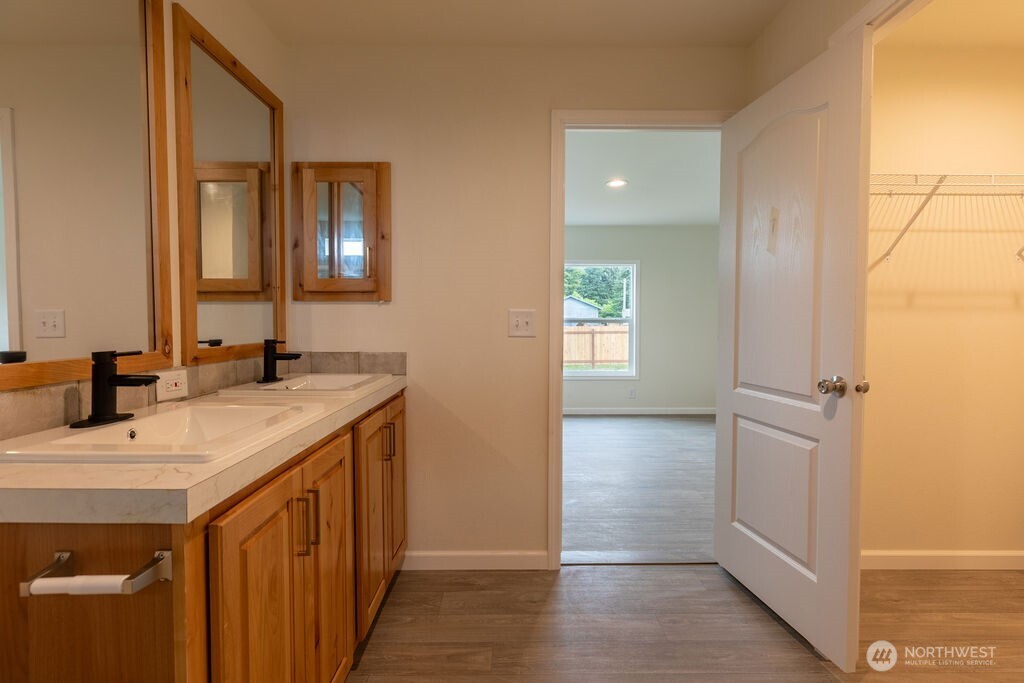 1450 Calawah Way Forks, WA 98331 - Photo 27 of 38 a bathroom with a sink a vanity and a mirror