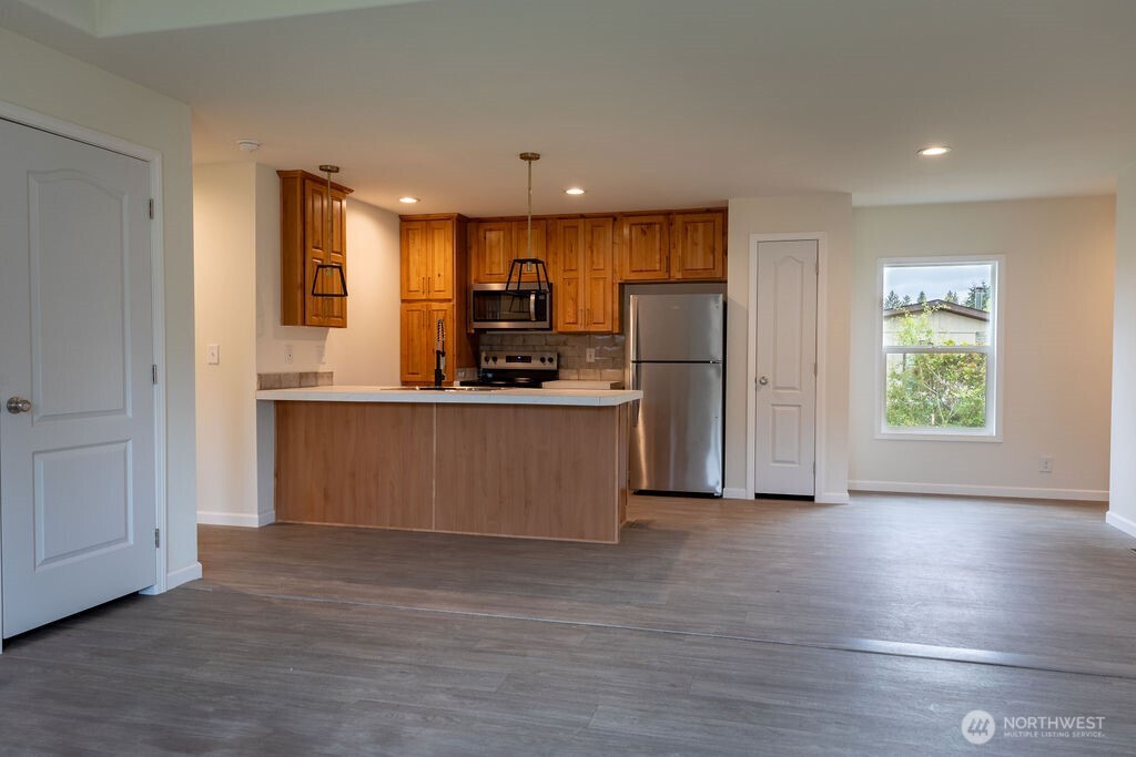1450 Calawah Way Forks, WA 98331 - Photo 29 of 38 a kitchen with stainless steel appliances a refrigerator and a stove top oven