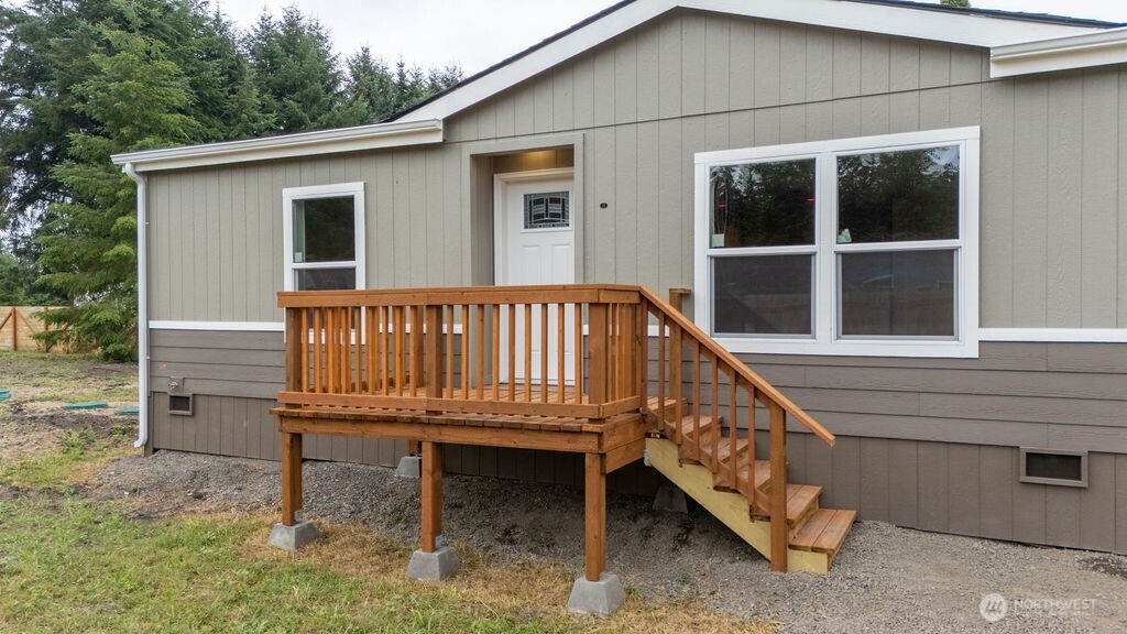 1450 Calawah Way Forks, WA 98331 - Photo 33 of 38 a view of a house with a wooden deck and a chair