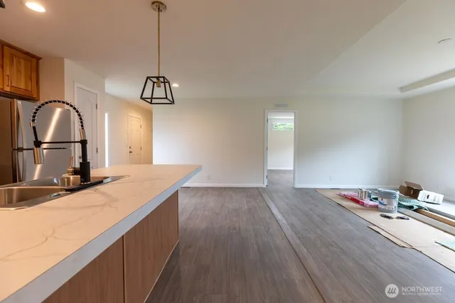 a kitchen with a sink and a stove top oven