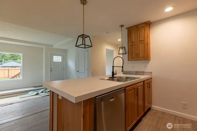 a kitchen with a sink a stove and cabinets