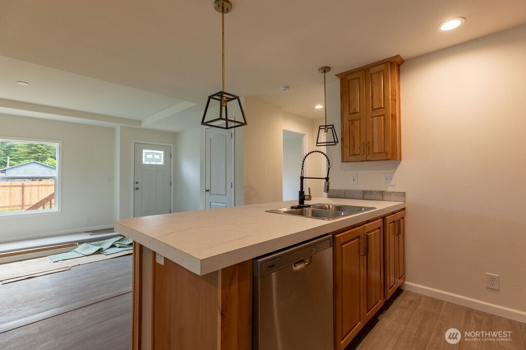1450 Calawah Way Forks, WA 98331 - Photo 10 of 38 a kitchen with a sink a stove and cabinets